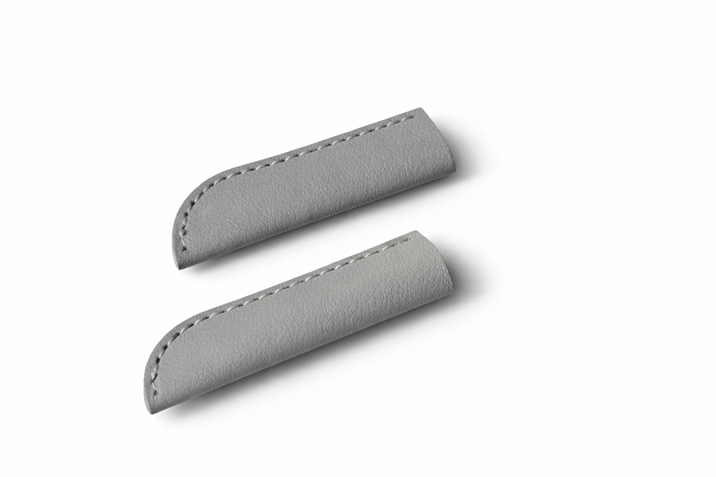 Two gray leather cap covers on a white background