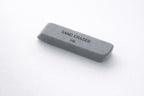 Gray sand eraser for a ballpoint pen and printed text on a white background