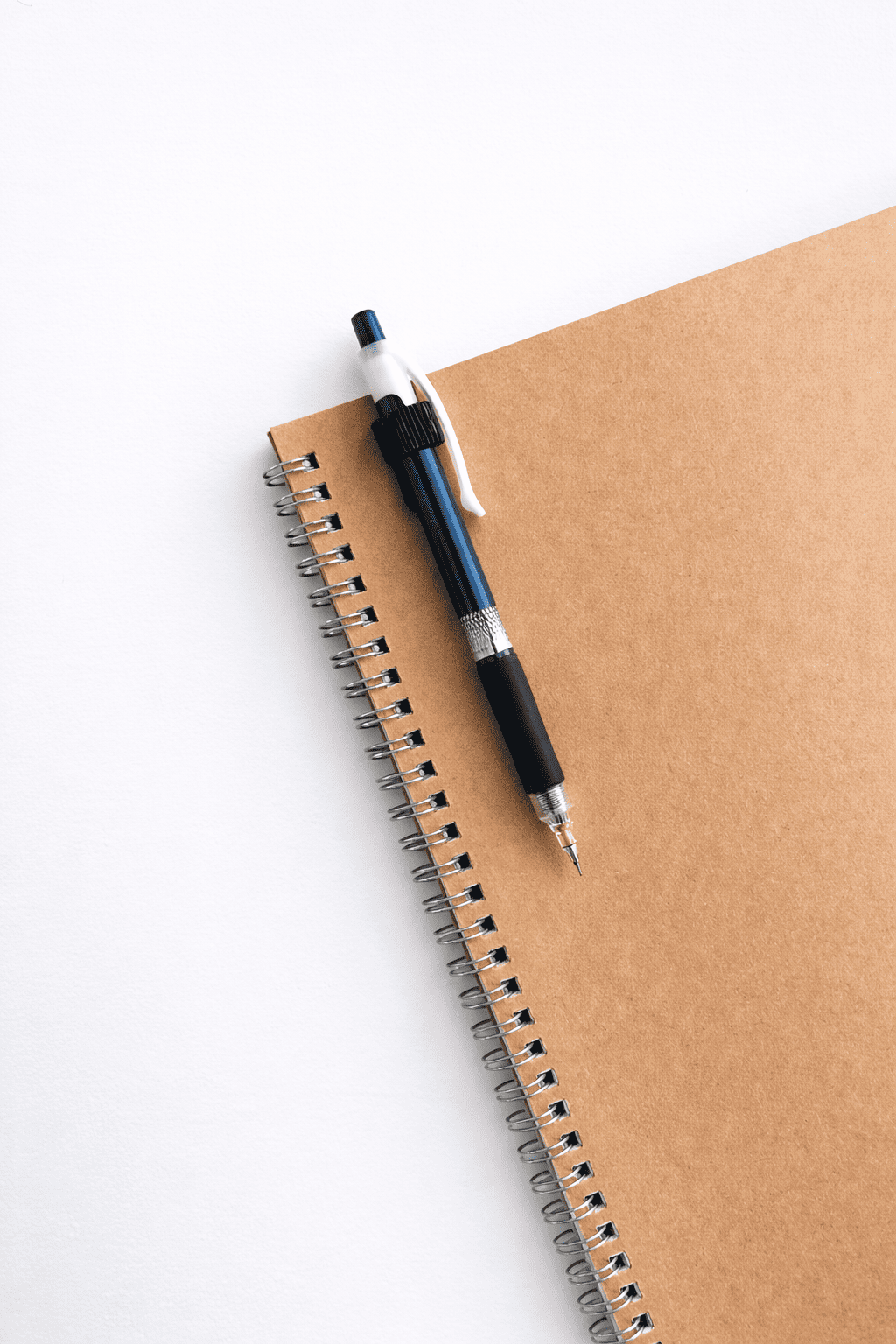 Notebook with pen holder clip on a white background