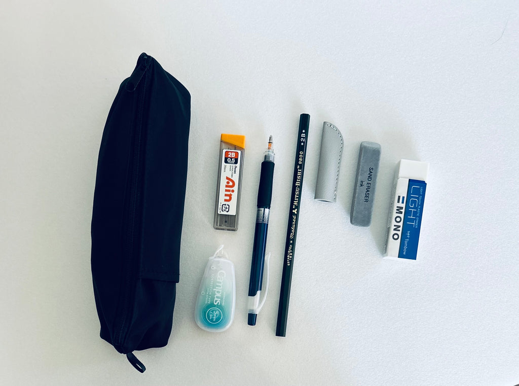 Pencil case, pencil, erasers, leads, sand eraser, soft eraser, mechanical pens, leather cap and other stationery items on a white background